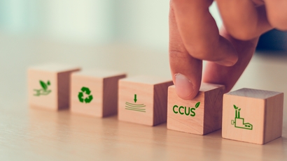 Carbon Capture, Utilization and Storage (CCUS) concept symbolized by five wooden blocks.